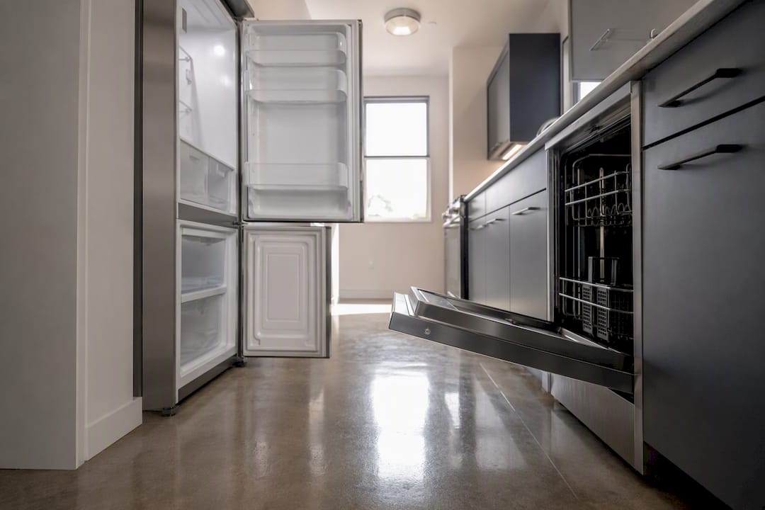 Open fridge and dishwasher doors showing aisle clearance