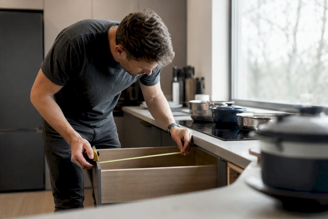 Measuring kitchen cabinet depth with tape measure