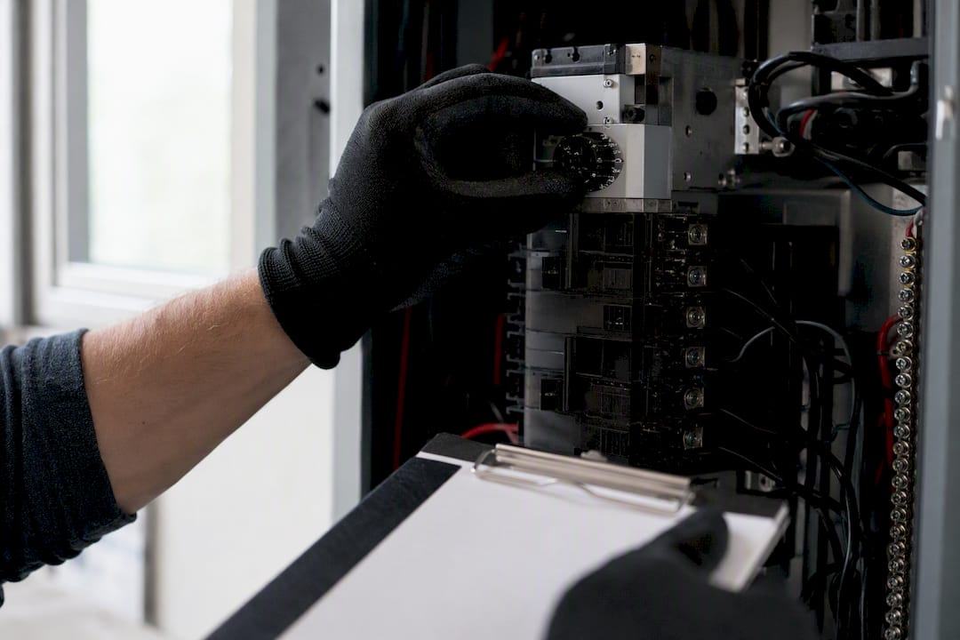 Electrician hands pointing at electrical panel label